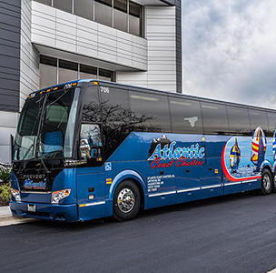 charter bus parked outside building